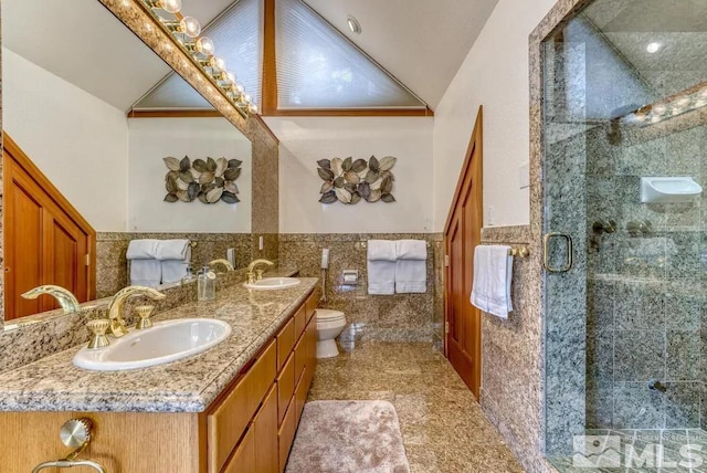 bathroom with oversized vanity, toilet, double sink, tile walls, and an enclosed shower