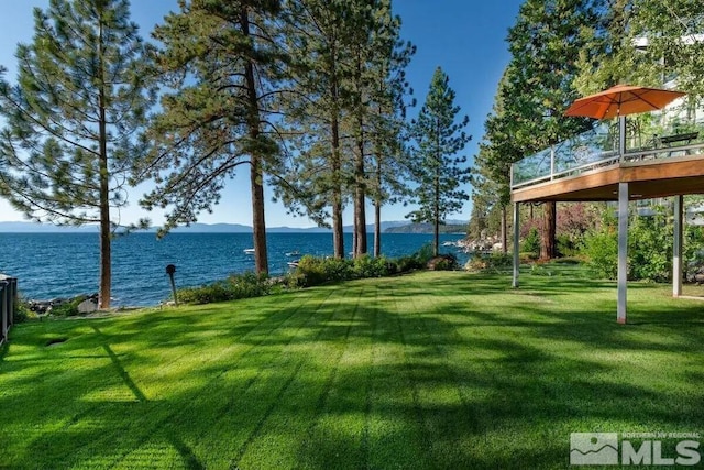 exterior space with a deck with water view