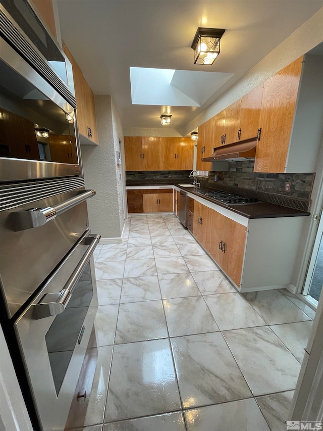 kitchen with backsplash, stainless steel appliances, light tile floors, and sink