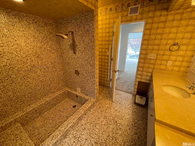 bathroom with tile walls and vanity