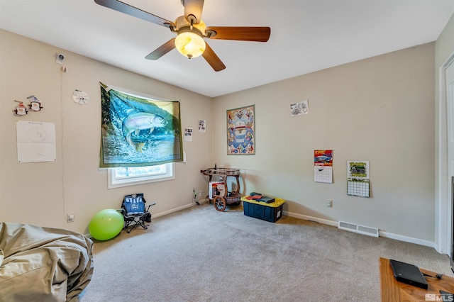 misc room with light carpet and ceiling fan