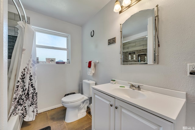 bathroom with toilet, tile floors, and vanity