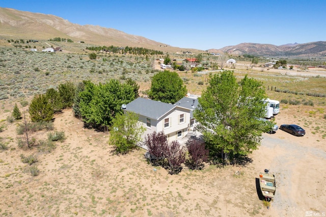 birds eye view of property with a mountain view