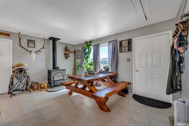 tiled foyer entrance featuring a wood stove