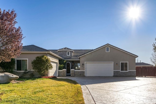 view of front of home with a front yard and a garage