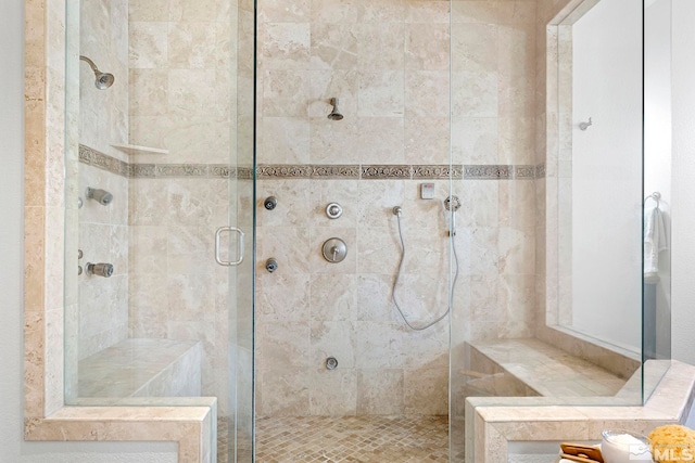 bathroom featuring a shower with shower door