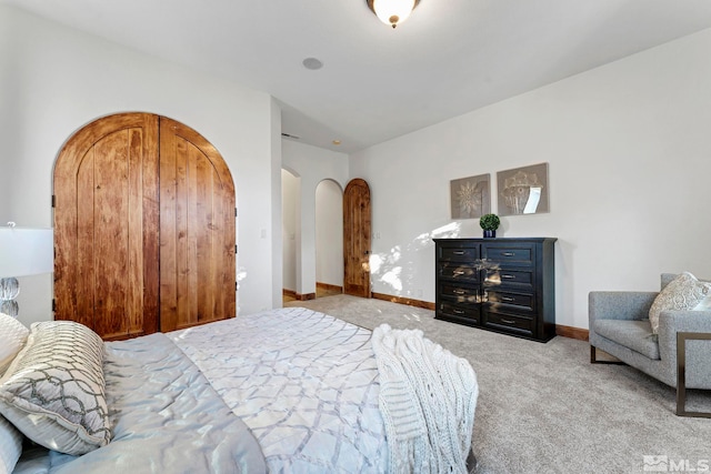 bedroom featuring light colored carpet