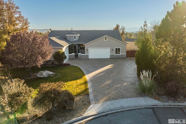 view of front of house with a front yard and a garage