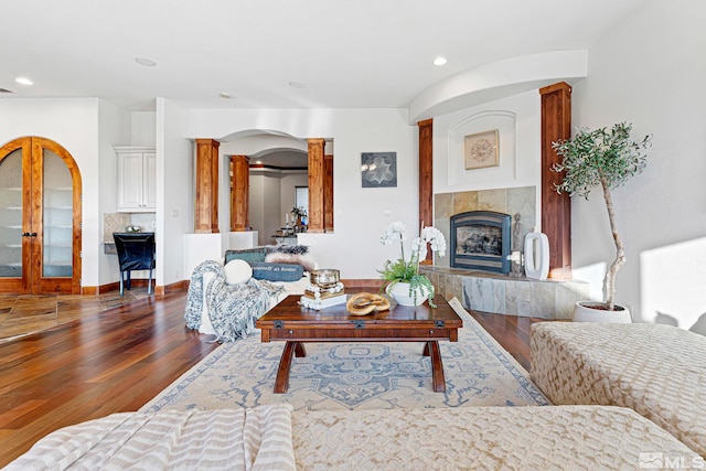 living room featuring french doors, hardwood / wood-style floors, and a fireplace