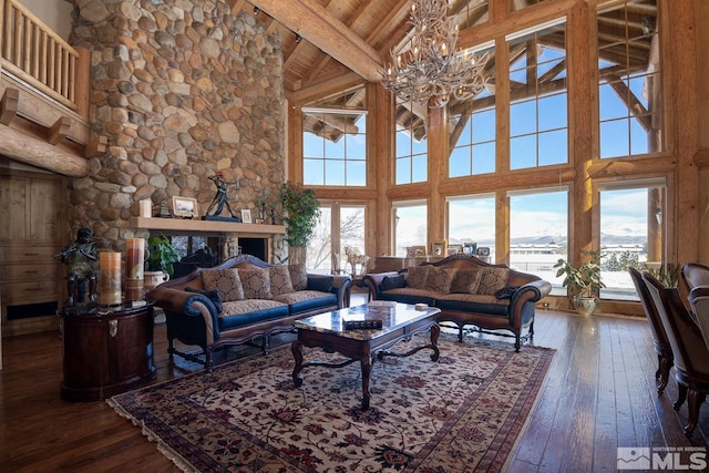 living room featuring high vaulted ceiling, an inviting chandelier, dark hardwood / wood-style floors, and beam ceiling