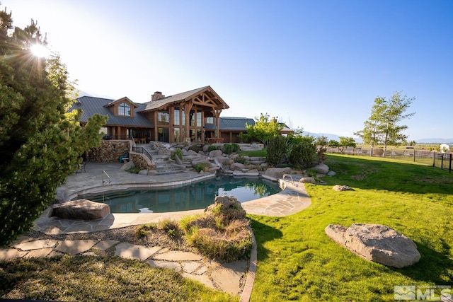 view of pool with a yard and a patio