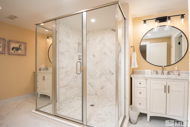 bathroom with a shower with door, tile floors, and vanity