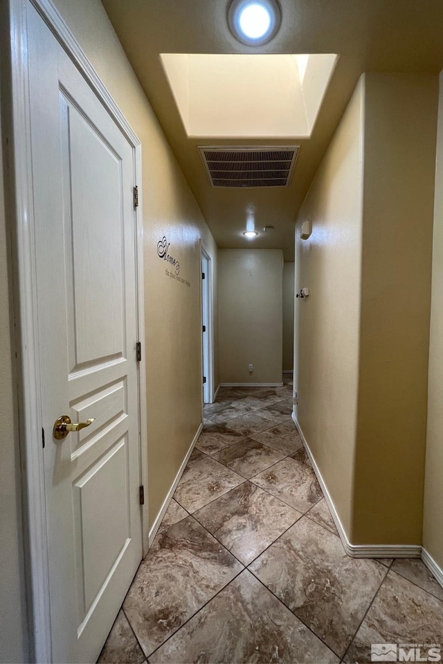 hallway featuring light tile floors