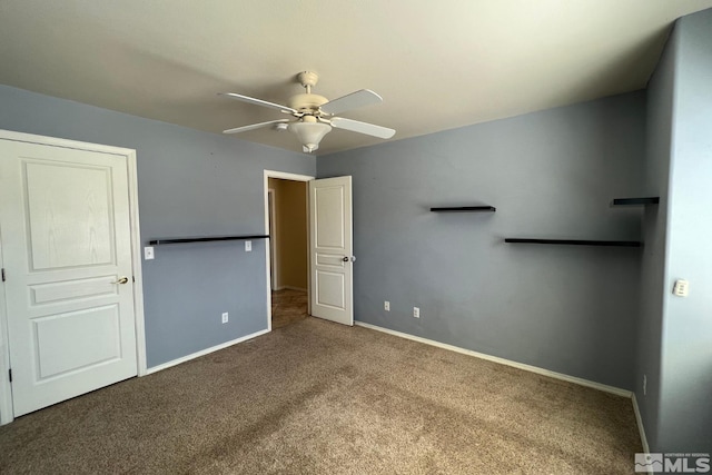 unfurnished bedroom featuring ceiling fan and dark colored carpet