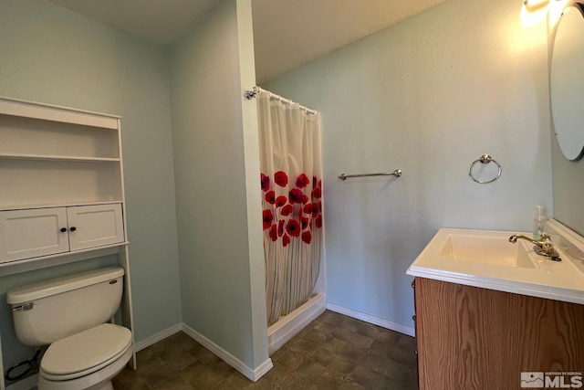 bathroom featuring tile flooring, vanity with extensive cabinet space, and toilet