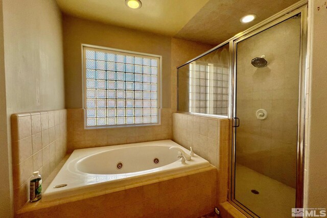 bathroom with shower with separate bathtub