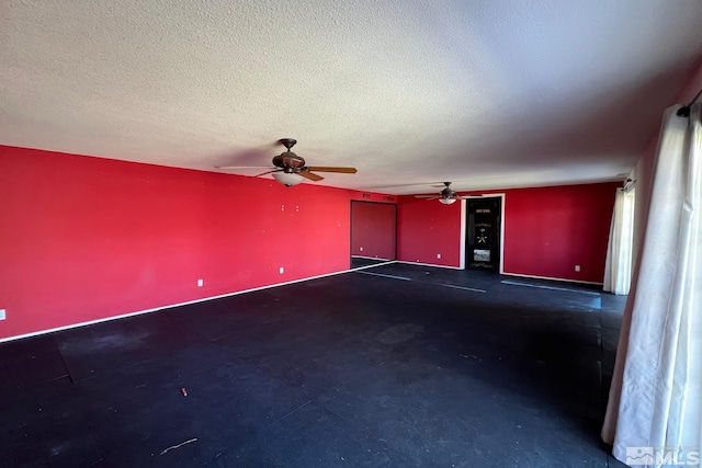 spare room featuring ceiling fan and a textured ceiling