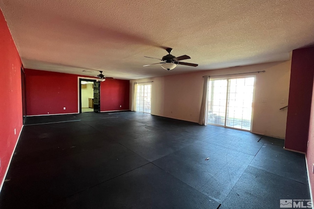 spare room with ceiling fan and a textured ceiling