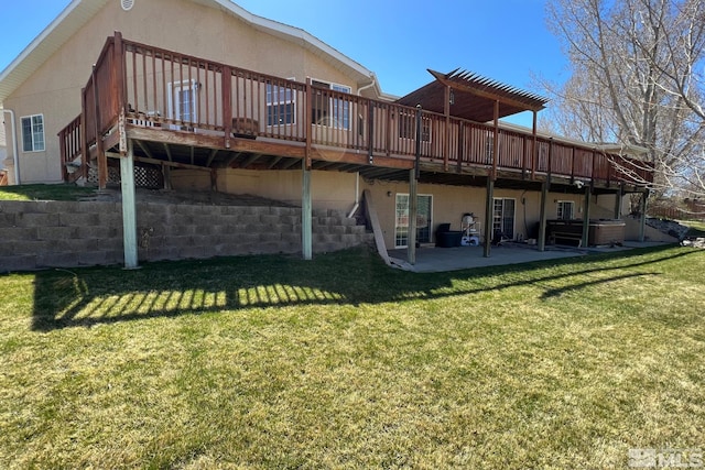 rear view of property with a wooden deck, a patio, and a yard