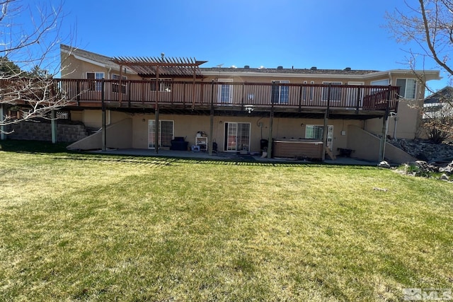 rear view of property with a wooden deck, a yard, and a patio