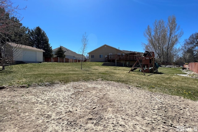 view of yard featuring a wooden deck and a playground