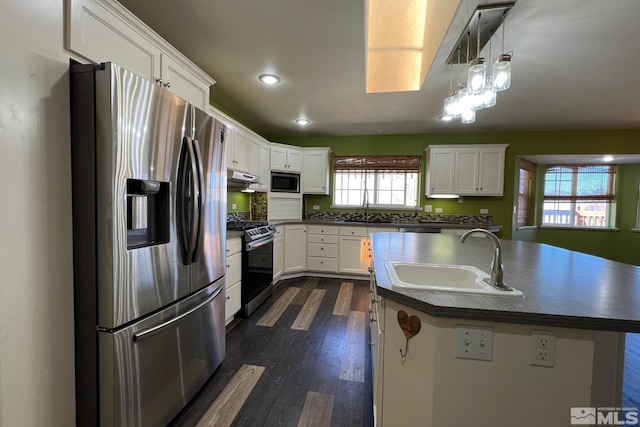 kitchen featuring appliances with stainless steel finishes, sink, dark hardwood / wood-style floors, and white cabinetry
