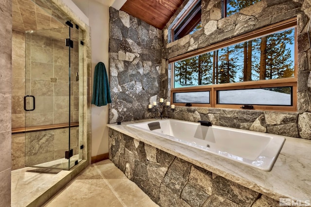 bathroom with tile flooring, lofted ceiling, and plus walk in shower