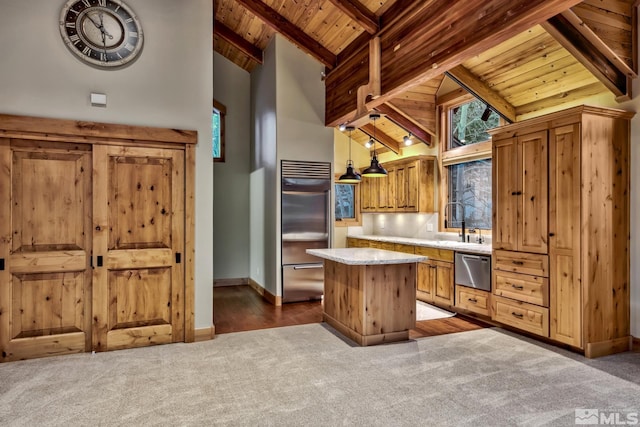 kitchen featuring carpet, lofted ceiling with beams, a kitchen island, decorative light fixtures, and wood ceiling