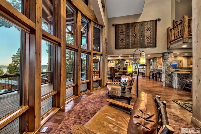 living room with hardwood / wood-style floors and a high ceiling