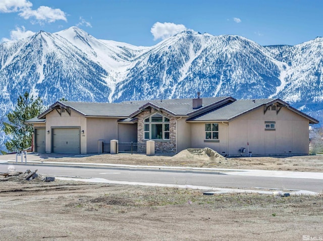 view of front of property with a mountain view and a garage