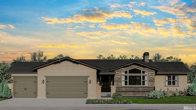 view of front of house featuring a lawn and a garage