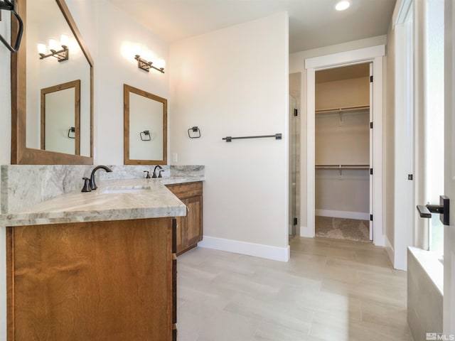 bathroom featuring double sink, tile floors, and vanity with extensive cabinet space