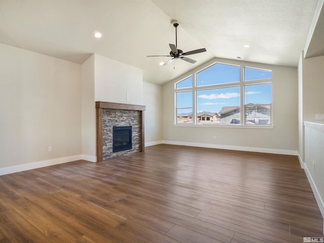 unfurnished living room with lofted ceiling, ceiling fan, dark hardwood / wood-style flooring, and a fireplace