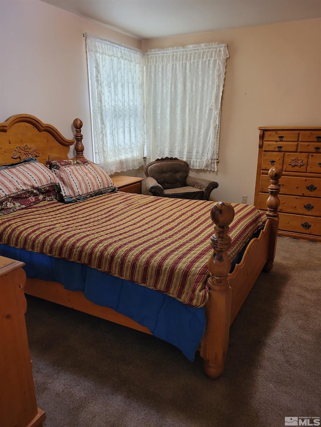 bedroom with dark colored carpet