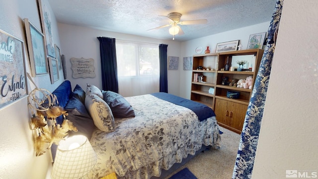 carpeted bedroom featuring ceiling fan and a textured ceiling