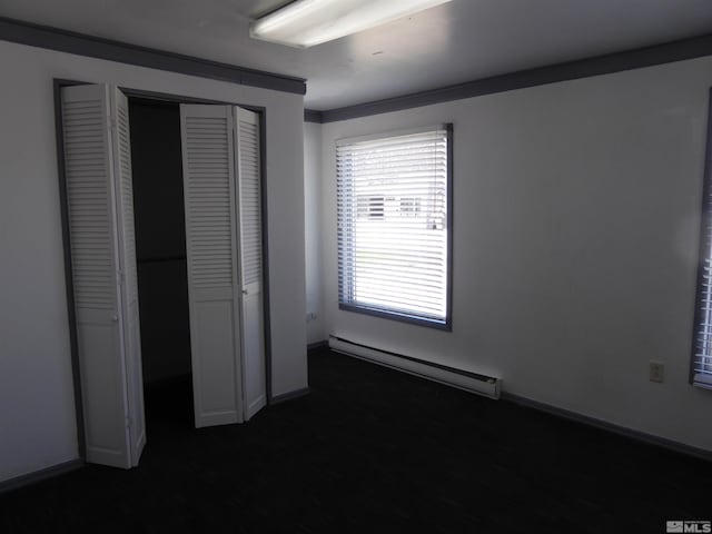 unfurnished bedroom featuring a baseboard radiator