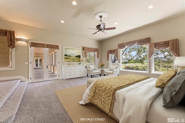 carpeted bedroom featuring access to outside, multiple windows, and ceiling fan