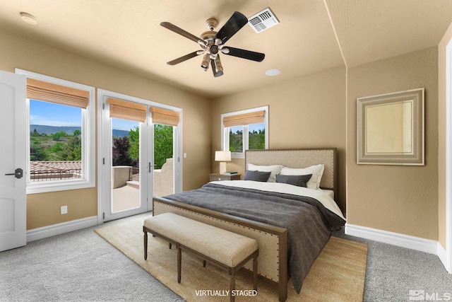 bedroom featuring ceiling fan, light carpet, and access to outside