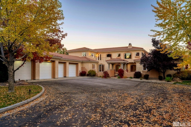 mediterranean / spanish house with a garage