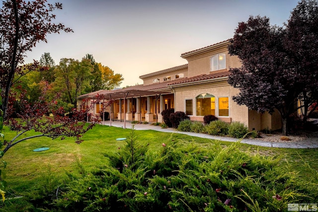 mediterranean / spanish-style house featuring a lawn