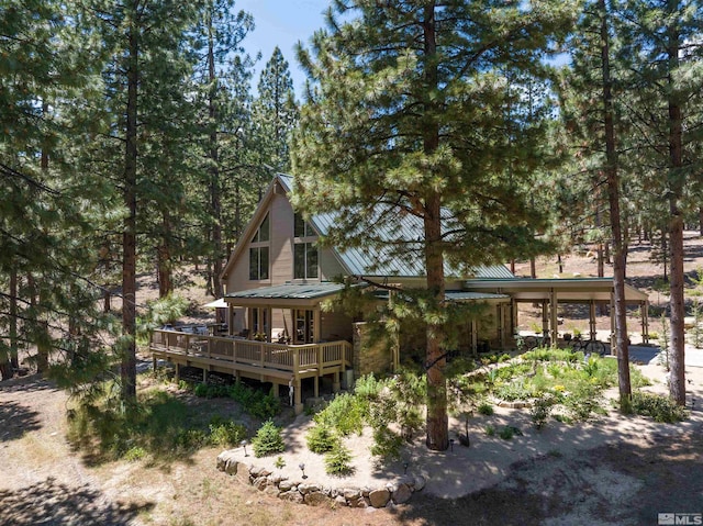 rear view of house featuring a wooden deck