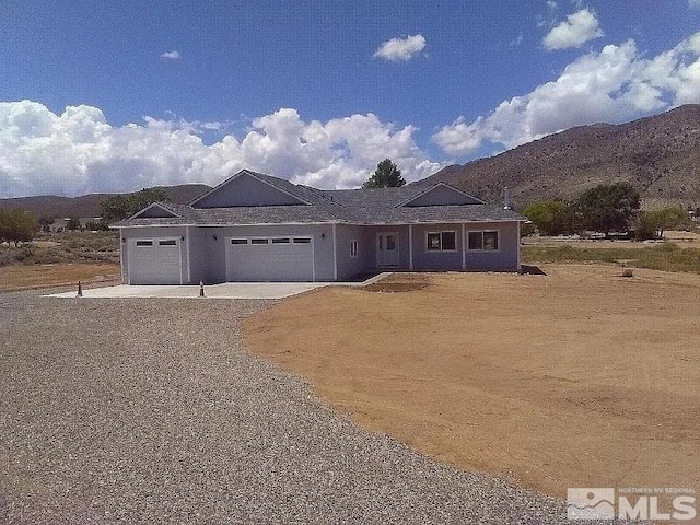 view of front facade featuring a mountain view and a garage