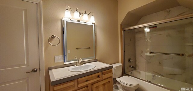 full bathroom with toilet, oversized vanity, and bath / shower combo with glass door