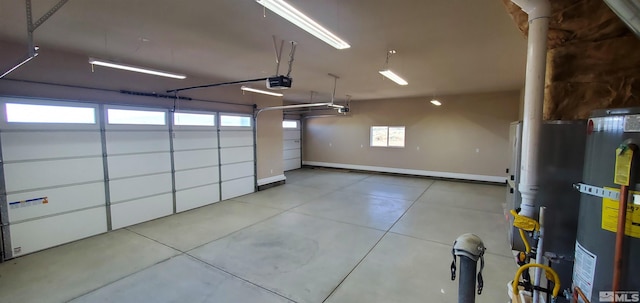 garage with gas water heater and a garage door opener