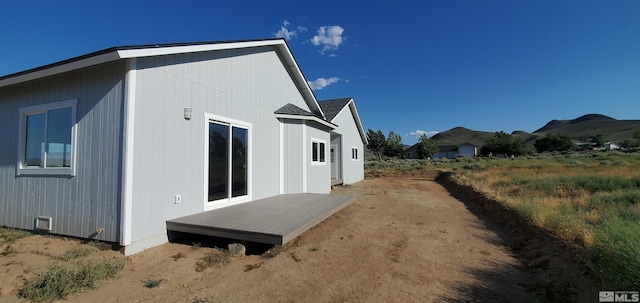 view of home's exterior featuring a deck with mountain view