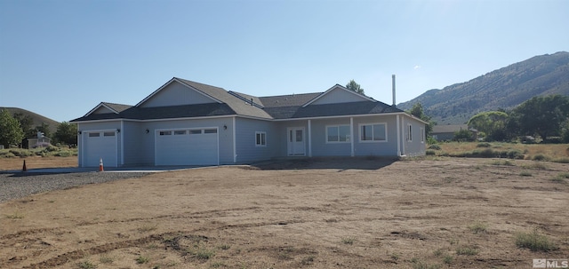 ranch-style house featuring a mountain view and a garage