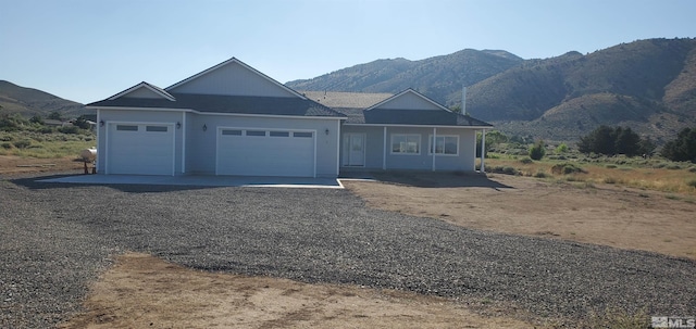 view of front of house with a garage and a mountain view