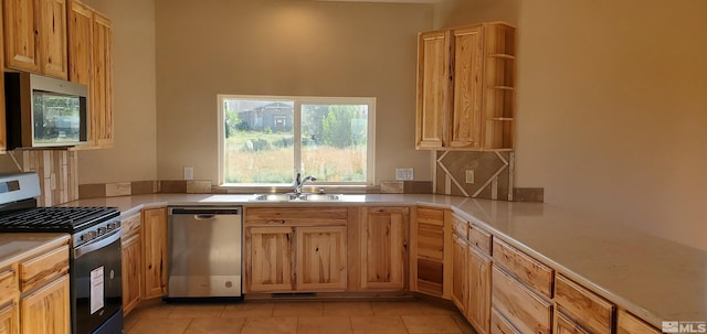 kitchen with light tile floors, sink, and stainless steel appliances