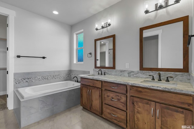 bathroom with dual vanity, tile flooring, and tiled bath