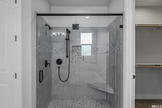 bathroom featuring a shower with shower door